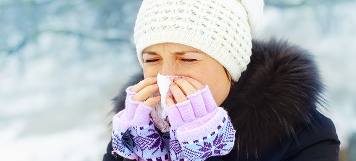 a woman who is blowing her nose