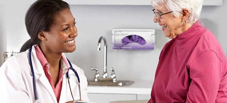 female doctor speaking with older woman