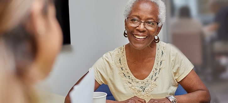 A woman talking to her local pharmacist 