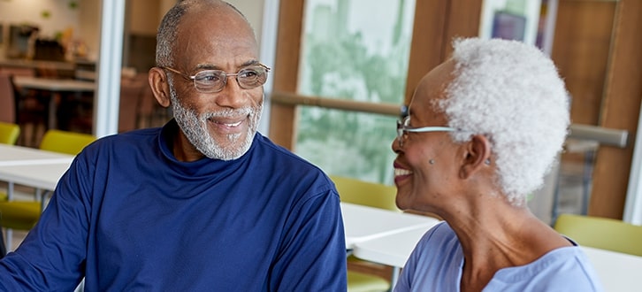 A man and woman smiling at each other