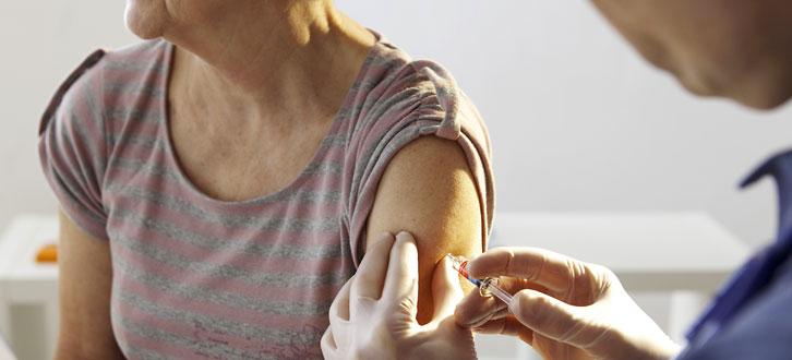 a woman getting a Band-Aid after getting her COVID-19 vaccine