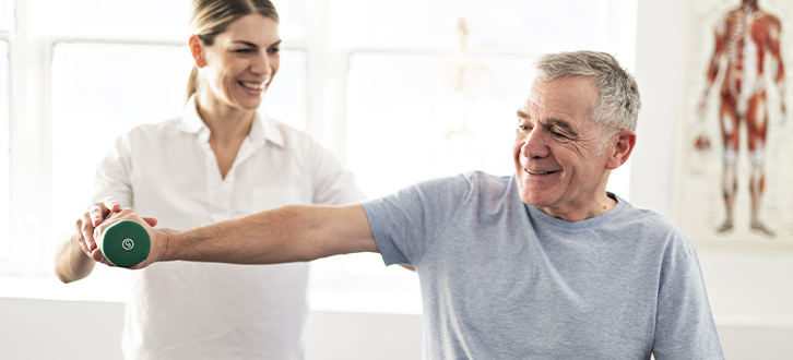 A man working with a physical therapists to find pain relief