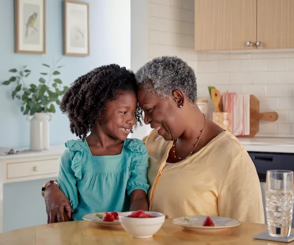 Grandmother and granddaughter eating breakfast