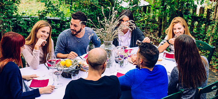 Group of friends eating at a table outside