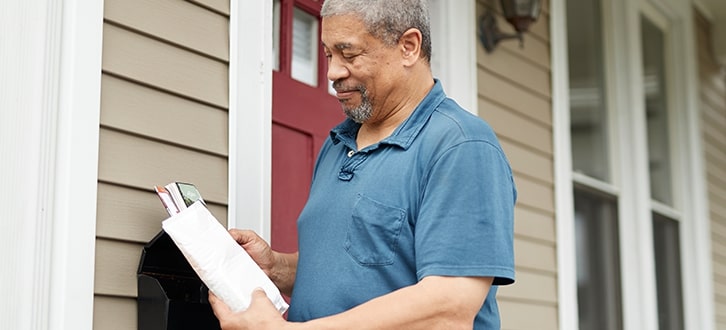 Man receiving prescription by mail