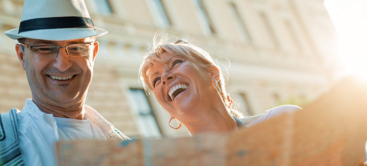Couple laughing and holding a map