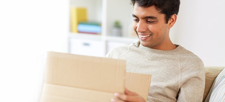 Man opening his prescription package