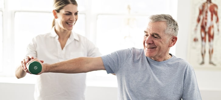 man working with a physical therapists to find pain relief 