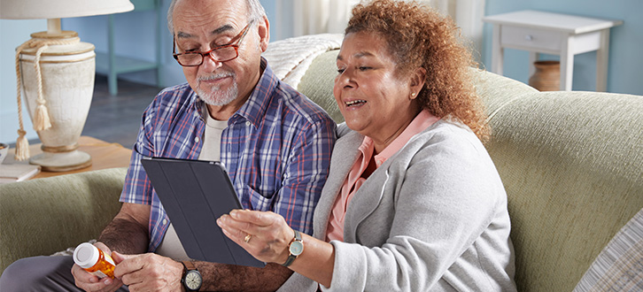 Couple smiling at laptop