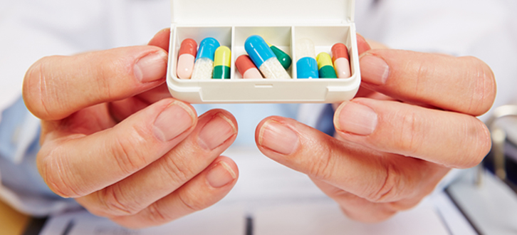 Pharmacist holding daily pill box