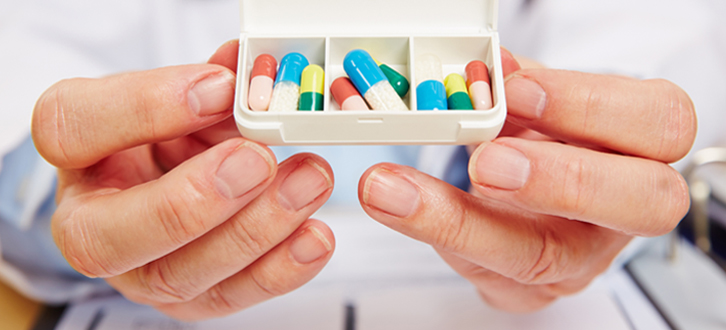 Pharmacist holding a daily pill box